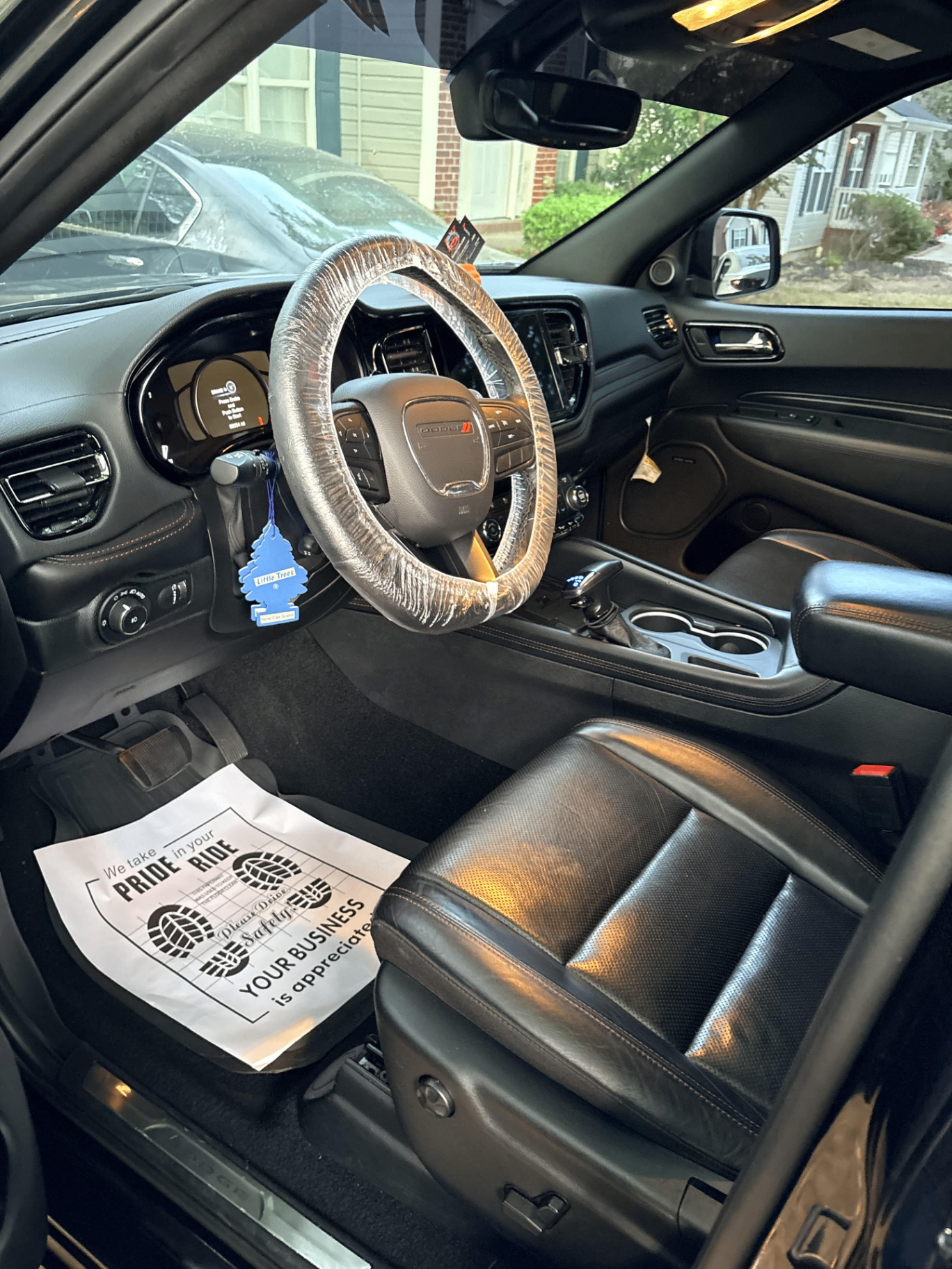 Freshly detailed Dodge interior with steering wheel cover and floor mat